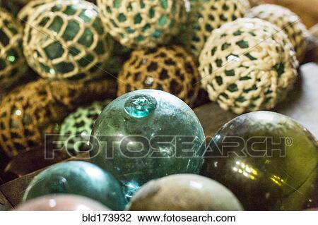 Stock Image - Close up of glass ball decorations with fishing net. Fotosearch