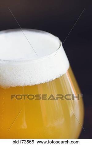 Stock Photography - Close up of glass of beer. Fotosearch