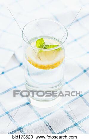 Close up of glass of herbal lemon water View Large Photo Image Stock Image - Close up of glass of herbal lemon water. Fotosearch