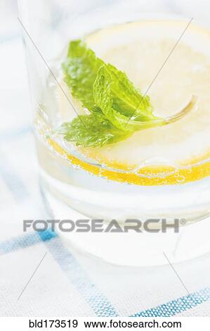 Close up of glass of herbal lemon water View Large Photo Image Stock Photo - Close up of glass of herbal lemon water. Fotosearch