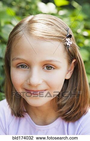 Stock Image - Close up of smiling girl outdoors. Fotosearch