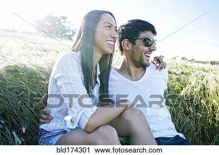 Couple hugging in field View Large Photo Image Stock Image - Couple hugging in field. Fotosearch