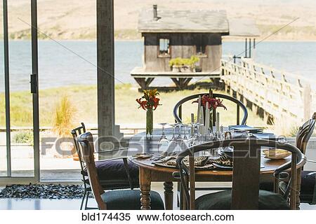 Stock Photography - Dining room table and dock house. Fotosearch