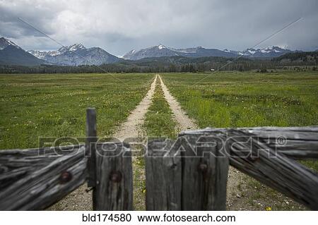 Dirt road in rural field View Large Photo Image Stock Image - Dirt road in rural field. Fotosearch