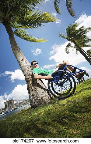 Disabled man playing in wheelchair on beach View Large Photo Image Stock Photo - Disabled man playing in wheelchair on beach. Fotosearch