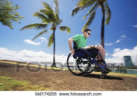 Disabled man racing in wheelchair by urban beach View Large Photo Image Stock Photography - Disabled man racing in wheelchair by urban beach. Fotosearch