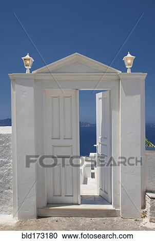 Stock Image - Door on hilltop over seascape. Fotosearch