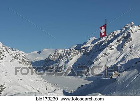 Flag over snowy slopes in remote mountains View Large Photo Image Stock Image - Flag over snowy slopes in remote mountains. Fotosearch