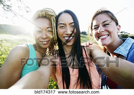Friends taking selfie outdoors View Large Photo Image Stock Photo - Friends taking selfie outdoors. Fotosearch