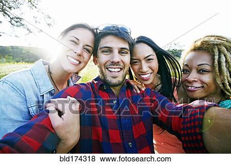 Friends taking selfie outdoors View Large Photo Image Stock Photo - Friends taking selfie outdoors. Fotosearch