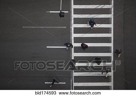 Stock Image - High angle view of pedestrians crossing street. Fotosearch