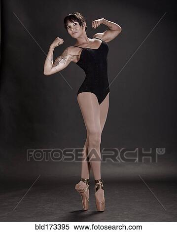 Stock Photography - Hispanic ballet dancer flexing muscles. Fotosearch
