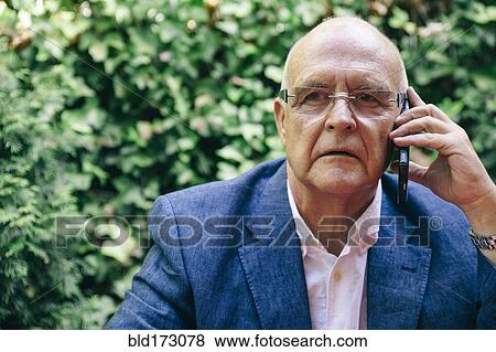 Stock Photo - Hispanic businessman talking on cell phone. Fotosearch