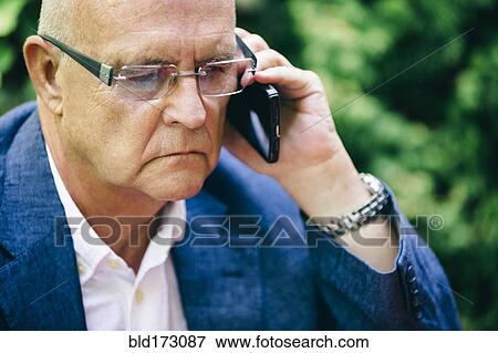 Stock Photo - Hispanic businessman talking on cell phone. Fotosearch