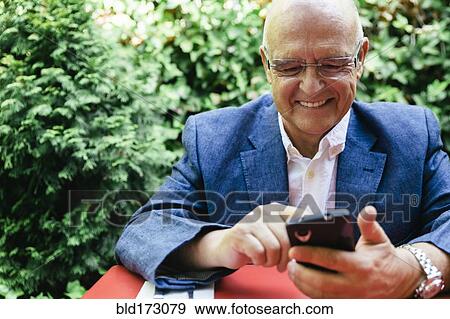 Hispanic businessman using cell phone View Large Photo Image Stock Photo - Hispanic businessman using cell phone. Fotosearch