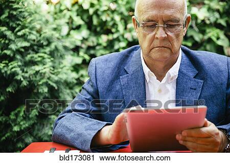 Hispanic businessman using digital tablet View Large Photo Image Stock Image - Hispanic businessman using digital tablet. Fotosearch