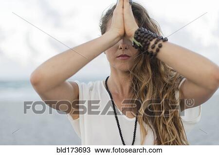 Hispanic woman meditating on beach View Large Photo Image Stock Image - Hispanic woman meditating on beach. Fotosearch
