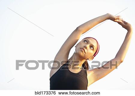 Hispanic woman stretching outdoors View Large Photo Image Stock Photograph - Hispanic woman stretching outdoors. Fotosearch