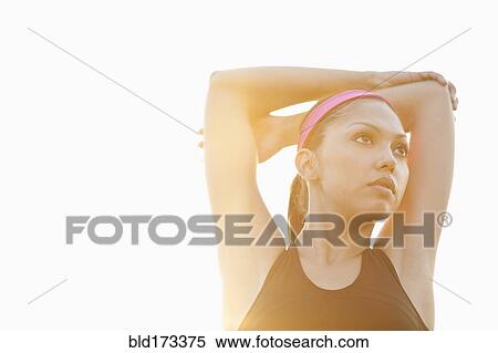 Hispanic woman stretching outdoors View Large Photo Image Stock Photography - Hispanic woman stretching outdoors. Fotosearch