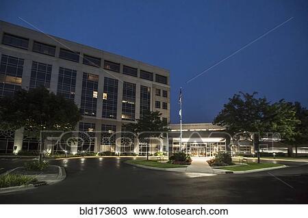 Stock Image - Illuminated driveway of hospital at night. Fotosearch