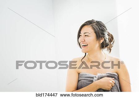 Stock Photo - Laughing woman wrapped in towel. Fotosearch