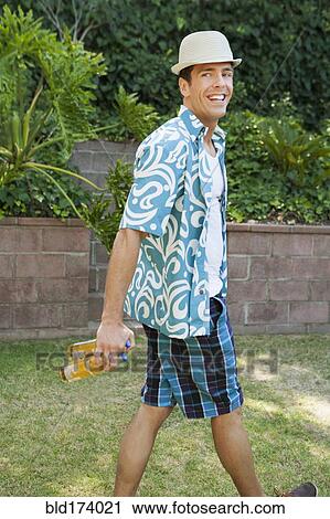 Man carrying cans of beer in backyard View Large Photo Image Stock Image - Man carrying cans of beer in backyard. Fotosearch
