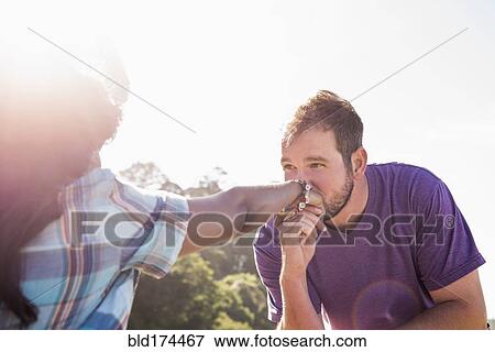 Stock Photo - Man kissing hand of girlfriend. Fotosearch