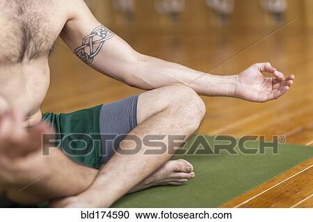 Man practicing yoga in studio View Large Photo Image Stock Image - Man practicing yoga in studio. Fotosearch