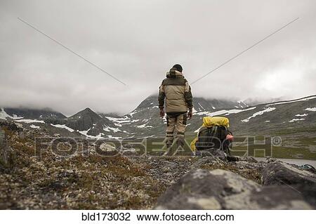 Mari backpacker standing in mountain field View Large Photo Image Stock Image - Mari backpacker standing in mountain field. Fotosearch