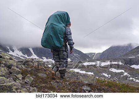 Picture - Mari backpacker walking on mountain path. Fotosearch