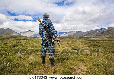 Mari hunter carrying crossbow in remote field View Large Photo Image Stock Image - Mari hunter carrying crossbow in remote field. Fotosearch