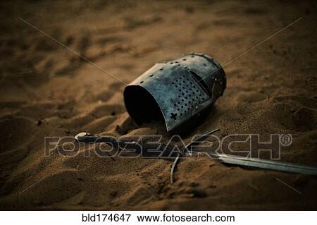 Medieval helmet and sword in sand View Large Photo Image Stock Photo - Medieval helmet and sword in sand. Fotosearch