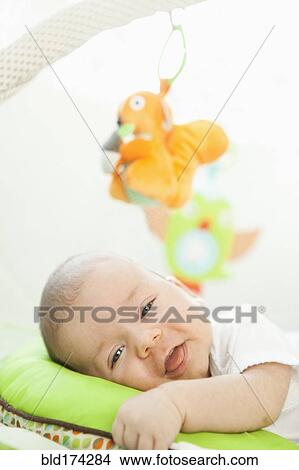 Mixed race baby laying on pillow View Large Photo Image Picture - Mixed race baby laying on pillow. Fotosearch