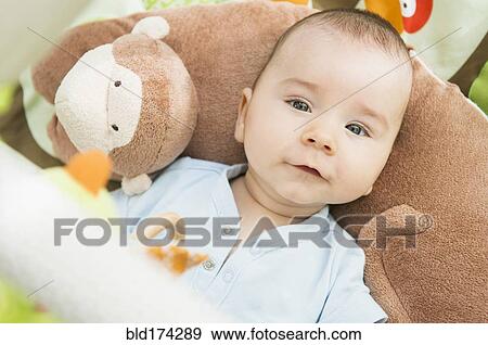 Stock Photo - Mixed race baby laying on pillow. Fotosearch