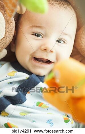 Mixed race baby laying under toys View Large Photo Image Stock Image - Mixed race baby laying under toys. Fotosearch