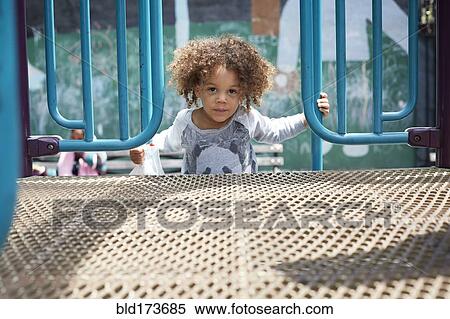 Stock Photography - Mixed race boy climbing on play structure. Fotosearch