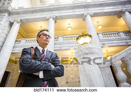 Mixed race businessman standing in courthouse View Large Photo Image Stock Image - Mixed race businessman standing in courthouse. Fotosearch