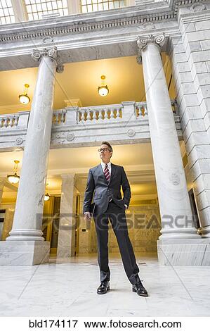 Mixed race businessman standing in courthouse View Large Photo Image Stock Photo - Mixed race businessman standing in courthouse. Fotosearch