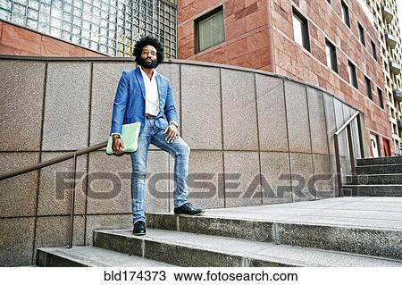 Mixed race businessman standing on steps View Large Photo Image Stock Image - Mixed race businessman standing on steps. Fotosearch