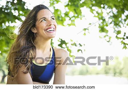 Stock Image - Mixed race woman smiling outdoors. Fotosearch