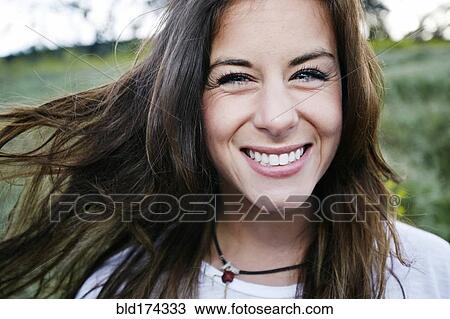 Stock Image - Mixed race woman smiling outdoors. Fotosearch