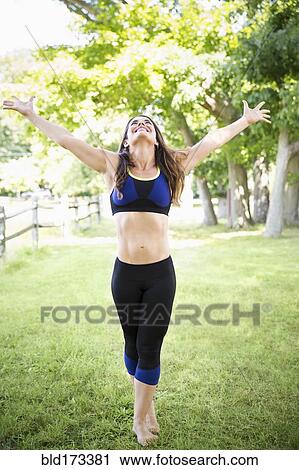 Mixed race woman standing in grass View Large Photo Image Stock Image - Mixed race woman standing in grass. Fotosearch