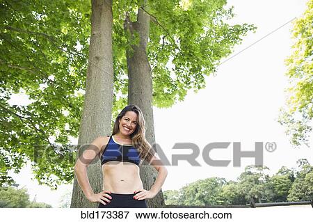Mixed race woman standing under trees View Large Photo Image Stock Photo - Mixed race woman standing under trees. Fotosearch