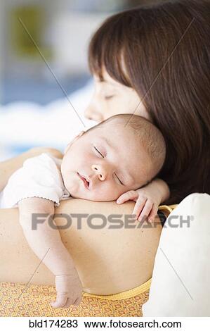 Mother holding sleeping baby View Large Photo Image Stock Image - Mother holding sleeping baby. Fotosearch