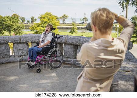 Mother photographing paraplegic daughter View Large Photo Image Stock Photo - Mother photographing paraplegic daughter. Fotosearch