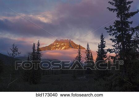 Mountain and clouds in remote landscape View Large Photo Image Stock Image - Mountain and clouds in remote landscape. Fotosearch