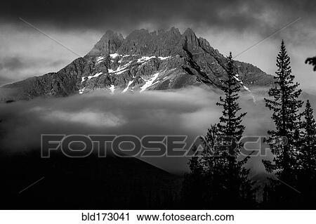 Stock Image - Mountain and clouds in remote landscape. Fotosearch