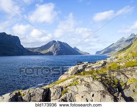 Stock Photograph - Mountains over river in remote landscape. Fotosearch