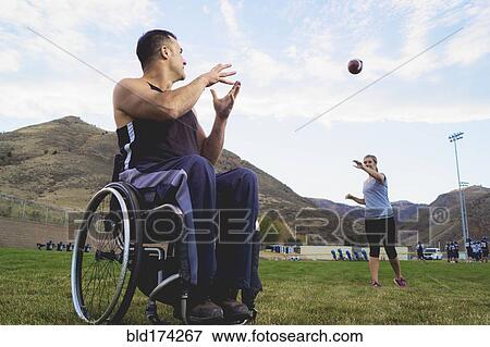 Paraplegic athlete in wheelchair with girlfriend tossing ball View Large Photo Image Stock Photo - Paraplegic athlete in wheelchair with girlfriend tossing ball. Fotosearch