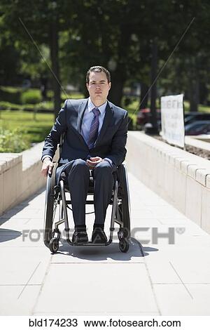 Paraplegic businessman in wheelchair on walkway View Large Photo Image Stock Image - Paraplegic businessman in wheelchair on walkway. Fotosearch